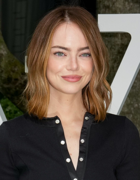 Emma Stone posing in a black cardigan